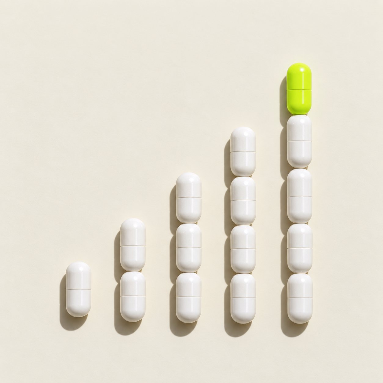 Supplement capsules arranged like a rising bar chart